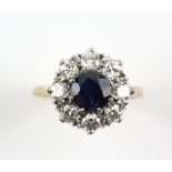 Vintage sapphire and diamond cluster ring, round cut sapphire weighing an estimated 1.64 carat,