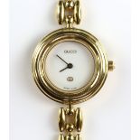 Gucci  A Ladies 11/12  gold tone bezel bangle bangle  wristwatch, signed white enamel dial ,with 6