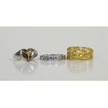 Three rings, one Signet with heart and angel emblem, stamped 14 ct and silver, ring size O, together