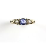 Antique sapphire and pearl ring; cushion cut sapphire, claw-set and flanked by pearls, pierced