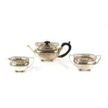 George V silver three-piece bachelor tea service, by Henry Matthews, Chester 1911, with pierced