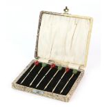 Set of six silver cocktail sticks with coffee bean finials, three red and three green, marked 925,