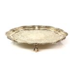 Victorian silver salver, the shaped circular body with beaded rim and chased centre, on three ball