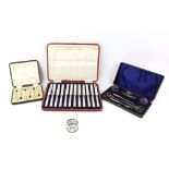 Selection of cased silver items including a set of twelve silver-handled butter knives, six coffee-