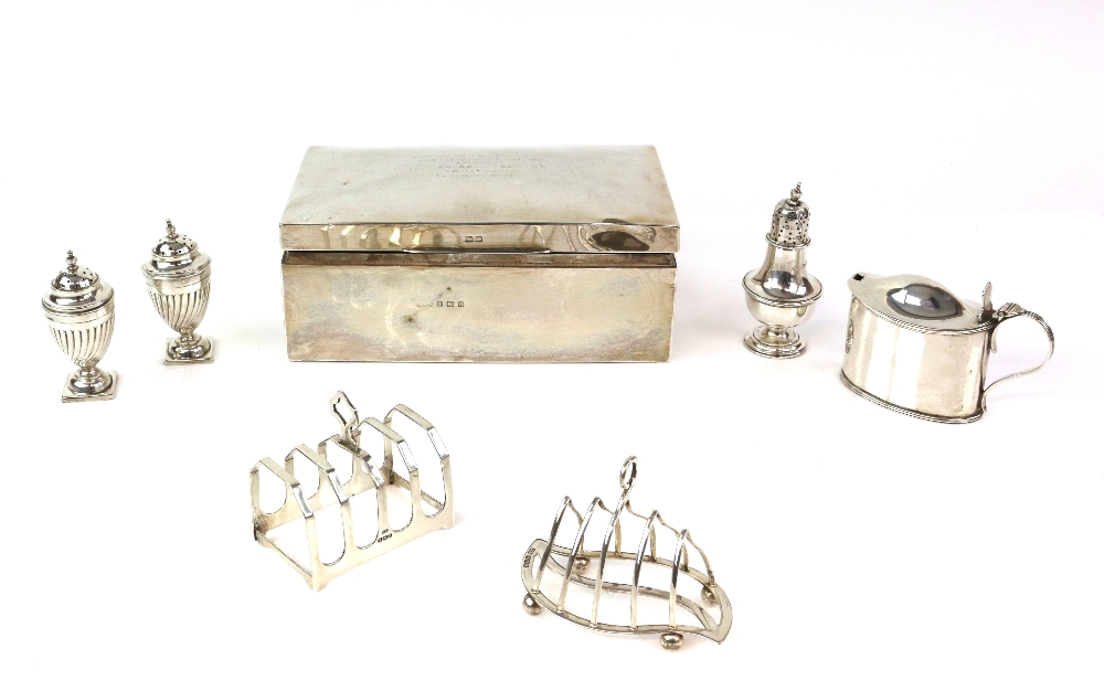 Group of silver items to include a George V cigarette box, Birmingham 1916, two toast racks, mustard