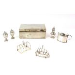 Group of silver items to include a George V cigarette box, Birmingham 1916, two toast racks, mustard