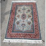 Persian cream ground rug, the central floral medallion with stylised floral urns and birds on a