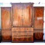 Early 19th Century flame mahogany triple wardrobe with central linen press above chest of 3 long