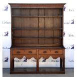 19th century oak dresser with three tier plate rack over two drawers, shaped apron and under-tier on