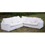 Large modern Heal's Easy corner sofa with cream upholstery and cushions, in three parts,