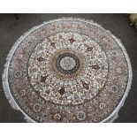 Persian style part silk circular rug, central floral medallion on a cream ground with stylised