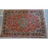 Persian Tabriz red ground rug, central floral medallion and scrolling foliage contained by repeating