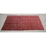 Turkoman Bokhara red ground rug, repeating gul motifs contained by repeating borders, 225 x 111cm