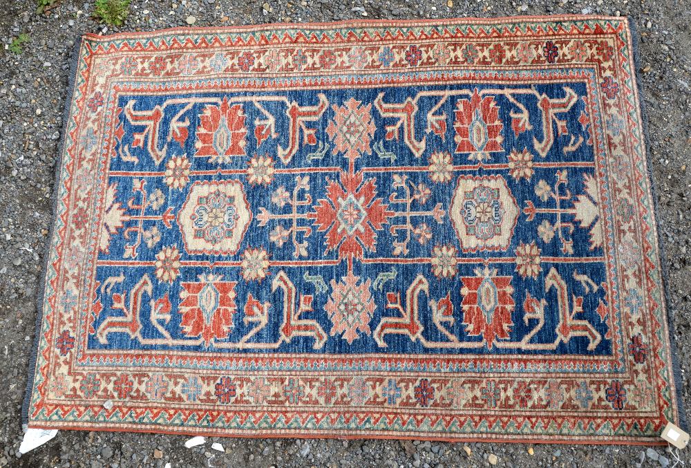 Kazak style rug, stylised floral motifs within floral panels, 144 x 103cm