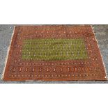 Turkoman/Shiraz rug, repeating gul motifs on a green ground within repeating geometric and floral