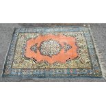 Persian style peach ground carpet, cream central floral medallion with floral spandrels contained