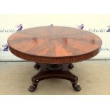 19th century flame mahogany breakfast table, the circular top on turned quatrefoil base and lion's