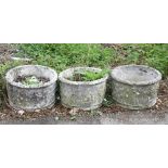 Three composite stone circular planters, relief decorated with putti, H39cm Diameter 61cm