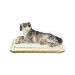 19th century Meissen figure of a recumbent hound on a shaped base, blue crossed swords mark, 15.