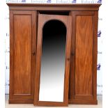 20th century mahogany wardrobe, two cupboard doors flanking a glazed central door enclosing