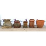 Three terracotta garden pots, with two terracotta chimney stacks, largest pot H33cm Diameter 34.