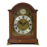George III style mahogany and brass mounted bracket clock, arched pediment above arched brass dial