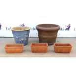 Three small rectangular terracotta planters together with a large garden pot and blue glazed