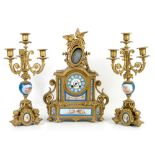 French gilt metal clock garniture, the clock with two birds and floral swags to finial, brass drum