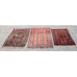 Afghan rug with repeating gul motifs on a red ground within repeating floral bands, 150 x 103cm,