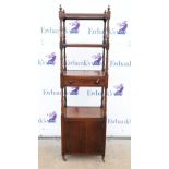 Early 19th century mahogany three tier whatnot with a central drawer above a cupboard with turned