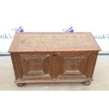 19th century made up chest with floral carving to panel sides and top, on bun feet. H45 x W74 x D32.