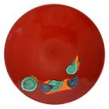 Poole pottery charger/wall plaque, with turquoise blue and orange decoration on a deep red ground,