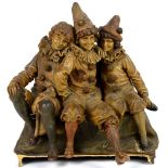 Goldscheider figure of three children dressed as clowns, on a shaped base, impressed marks and