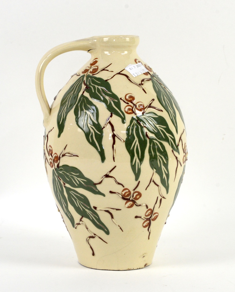 C H Brannam, Barnstaple studio pottery jug with green leaves and brown berries decoration on a cream - Image 2 of 10