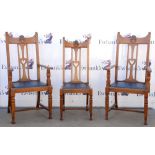 Ten early 20th century Arts and Crafts oak dining chairs, carved detailing and heart pierced