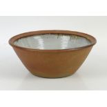 Studio pottery bowl, the inner with mottled beige glaze and brown drips from the unglazed rim,