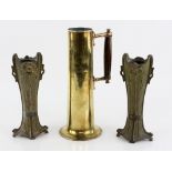 AMENDED DESCRIPTION AND ESTIMATE A brass ewer of cylindrical form with spreading foot, wooden handle