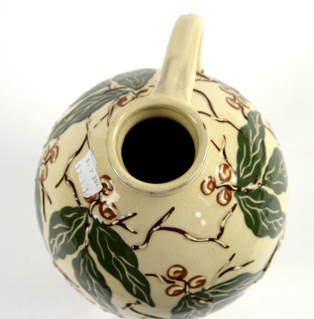 C H Brannam, Barnstaple studio pottery jug with green leaves and brown berries decoration on a cream - Image 9 of 10