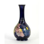 Moorcroft clematis vase with purple, yellow and pink flowers on a cobalt ground, impressed marks