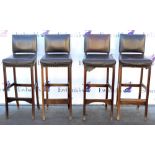 Four similar 20th century leather bar stools on straight tapered supports.