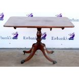 19th century mahogany rectangular tilt top table on quatrefoil base on castors. 114W x 73H x 88D