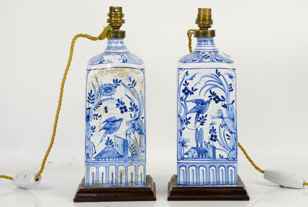 Pair of blue and white ceramic lamps decorated with birds of paradise, with a gilt-metal oil lamp