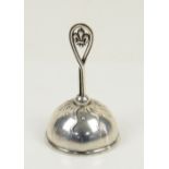 Sterling silver bell with fleur de li design to handle and sunburst stream to top of the bell