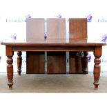 20th century mahogany dining table with three extra leaves on turned legs and castors. 225W x 70H
