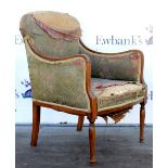 Early 20th century mahogany armchair with line inlaid decoration, floral upholstery on turned legs.