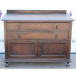 18th Century style oak side cupboard with 2 long drawers above a cupboard on bun feet.