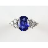Modern sapphire and diamond ring, oval cut sapphire weighing an estimated 2.85 carats, with a