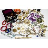 A group of costume jewellery, including base metal dress rings, beaded necklaces, brooches,