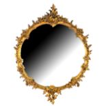 Reproduction mirror with scrolling foliate frame and circular glass plate, H87cm W.69cm Question