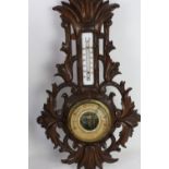 Black forest style carved aneroid barometer, H48cm